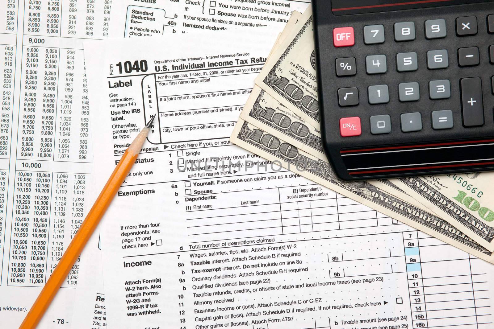 Tax time - Closeup of U.S. 1040 tax return with pencil and calculator