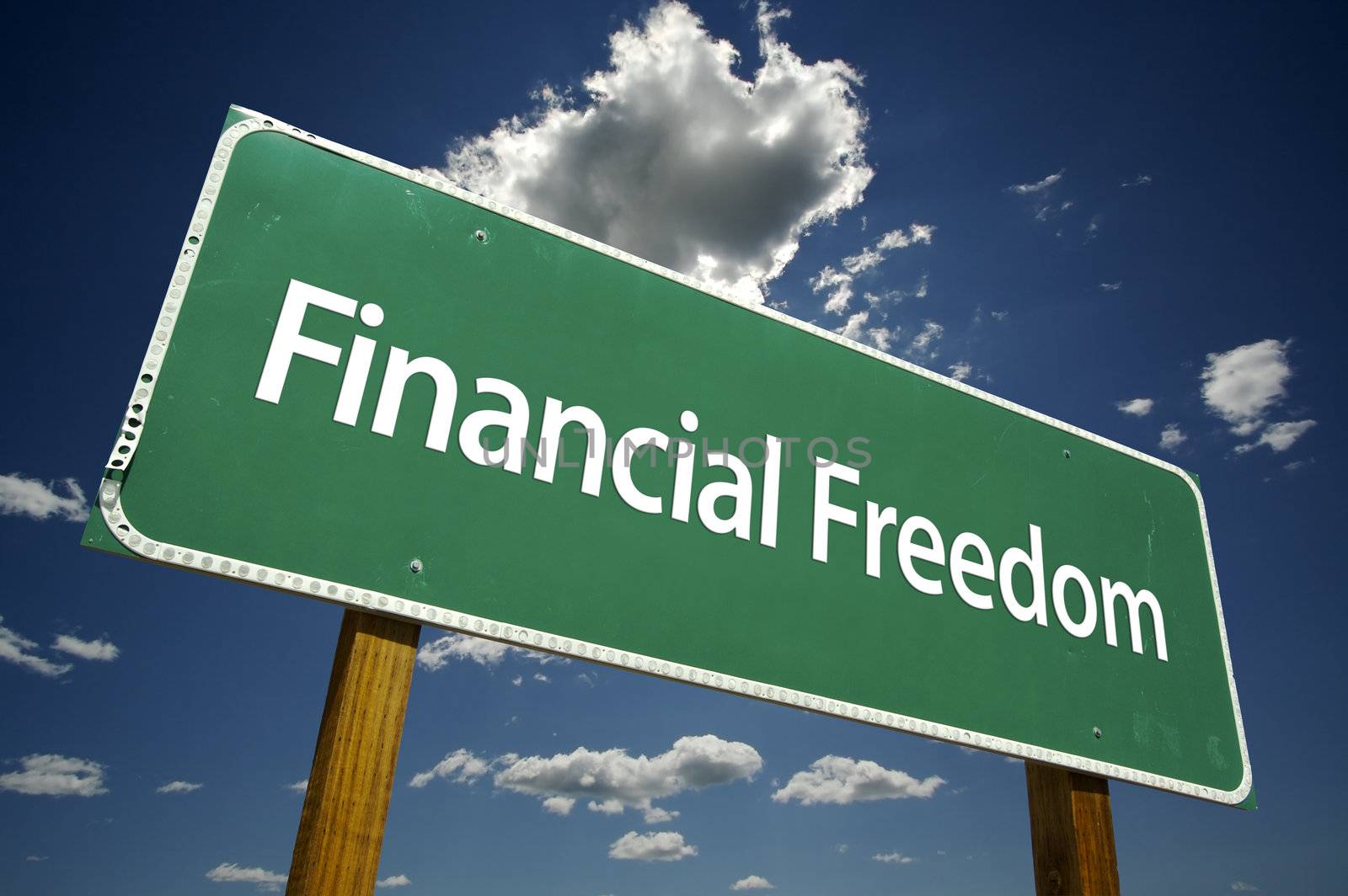 Financial Freedom Road Sign with dramatic clouds and sky.