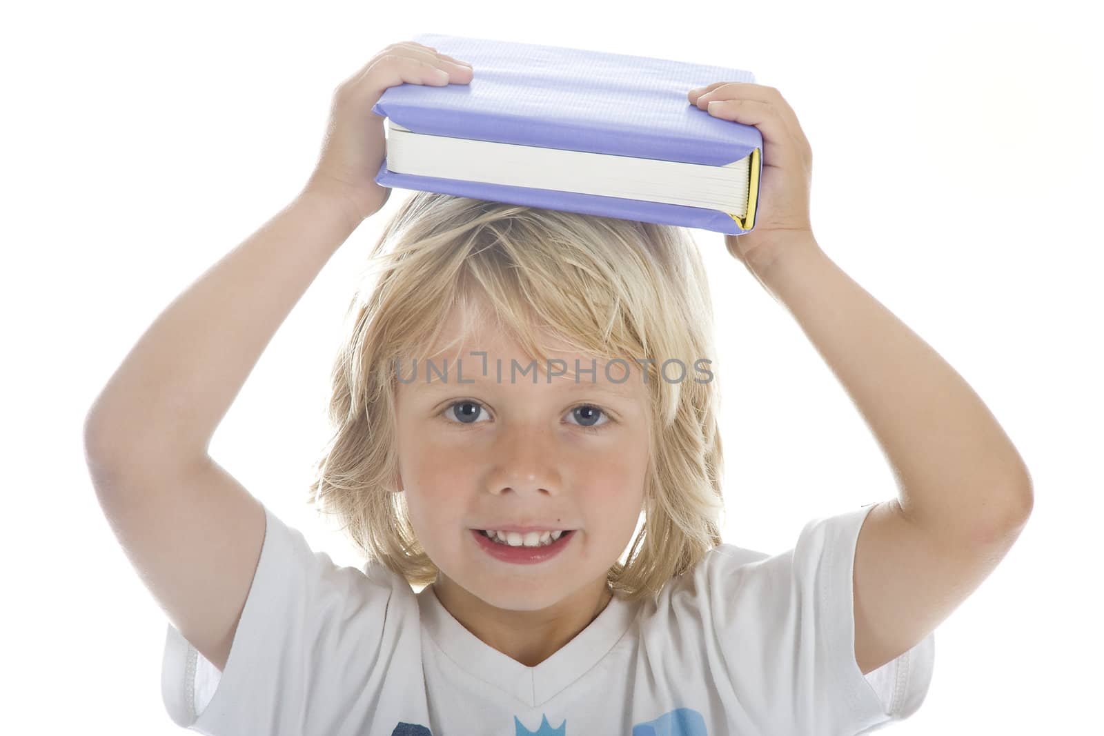 a young student with a book on his head