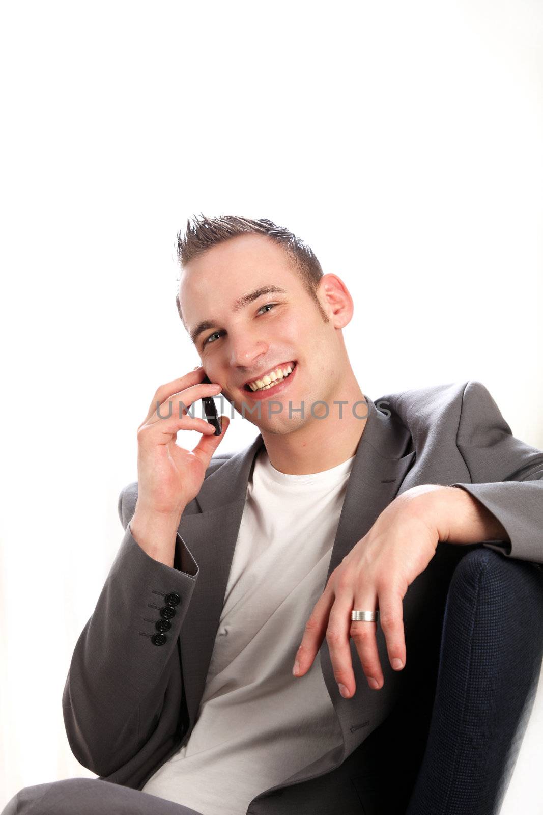 successful businessman smiling with a phone in his hand- copy space