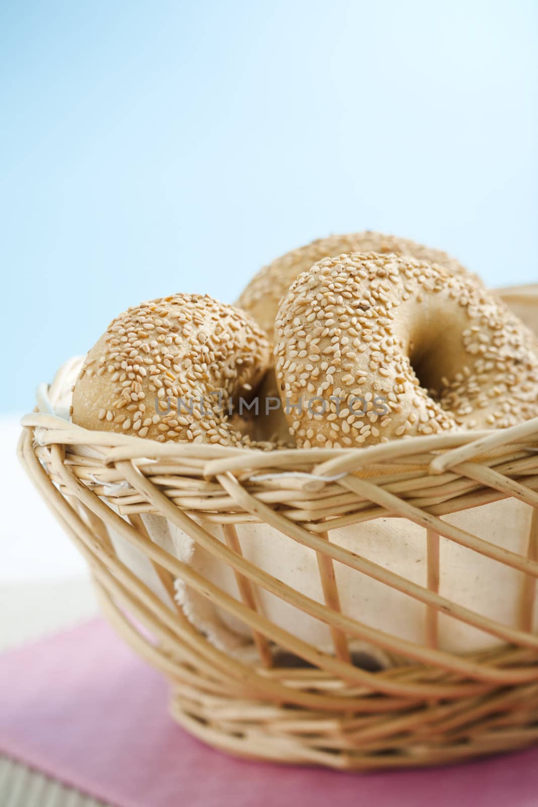 Breakfast bagels on the kitchen table over blue background