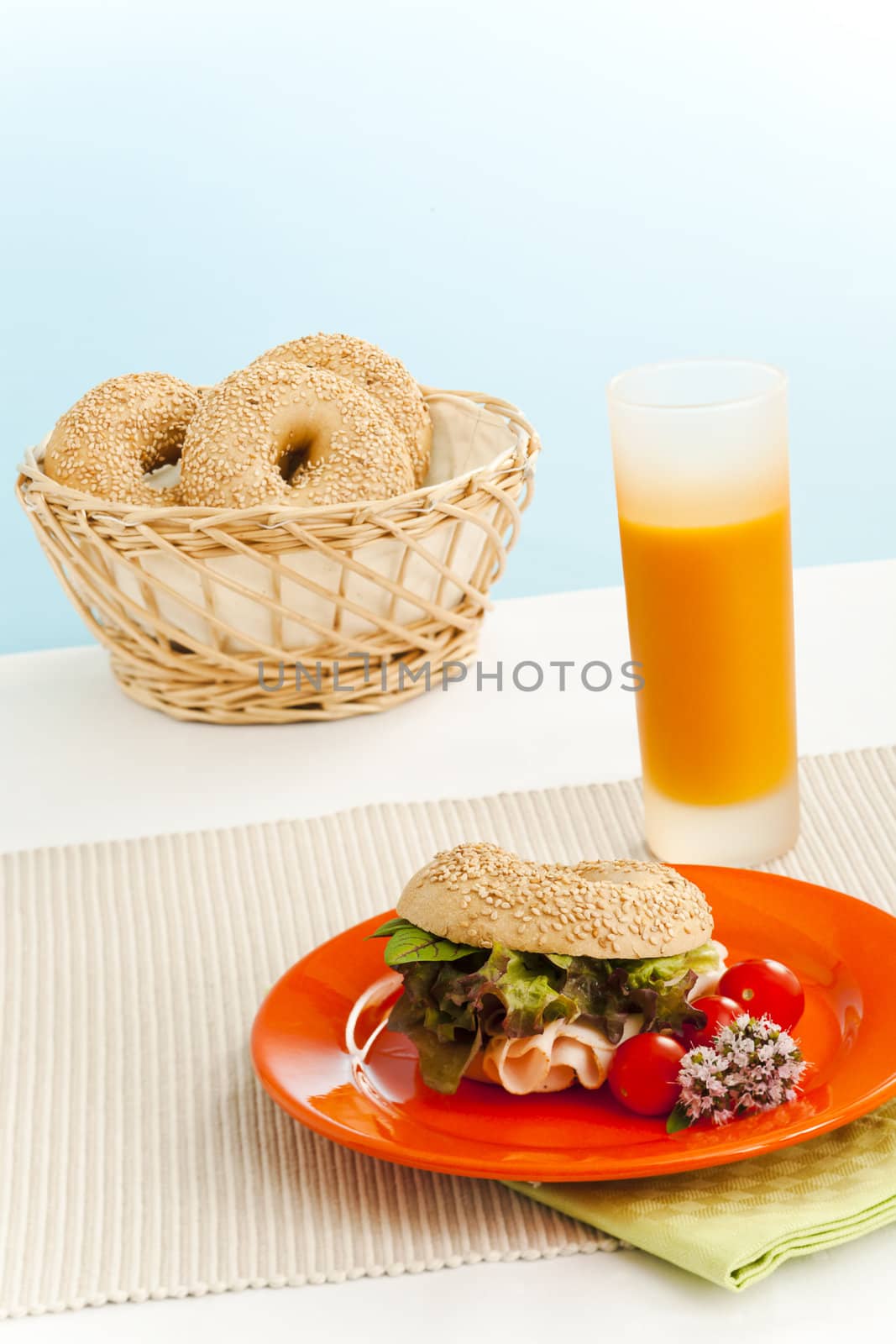 Breakfast bagels on the kitchen table over blue background