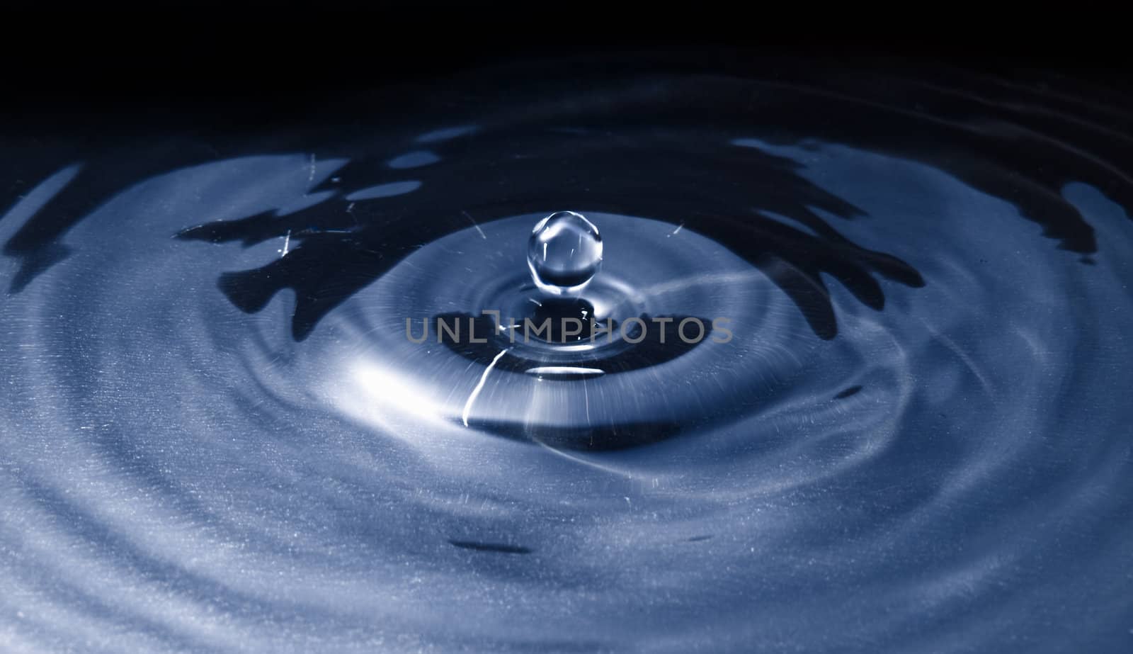 Water droplet frozen in action by off camera flash