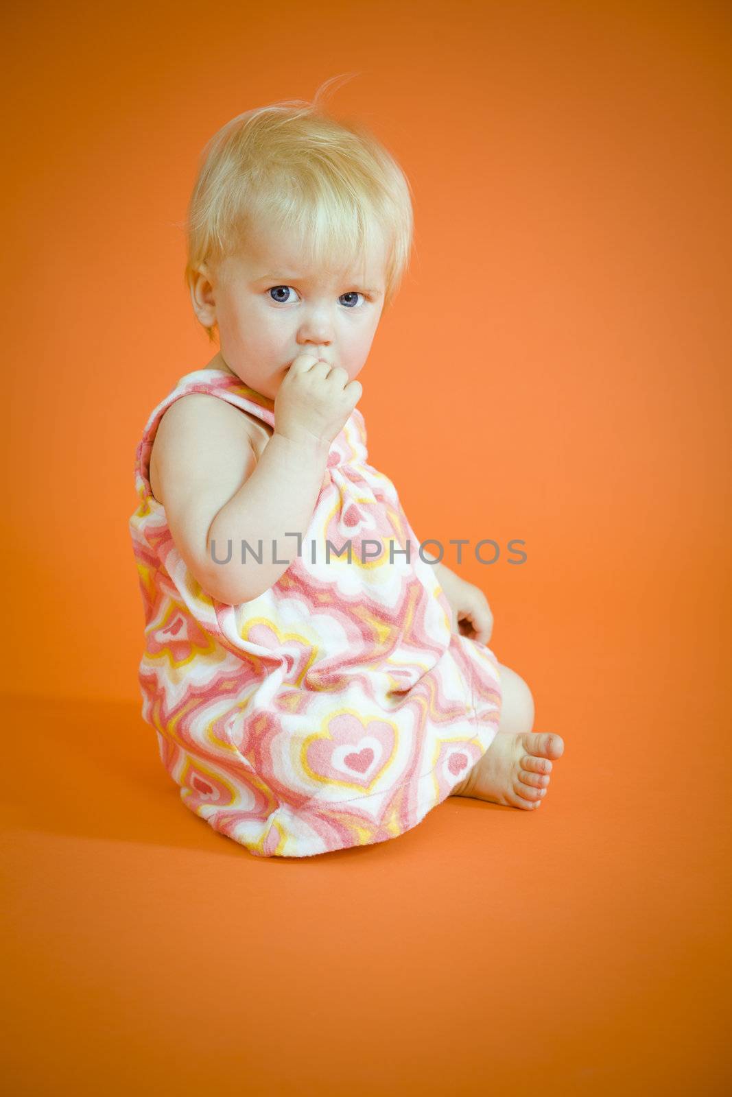 Small baby girl sitting on the floor