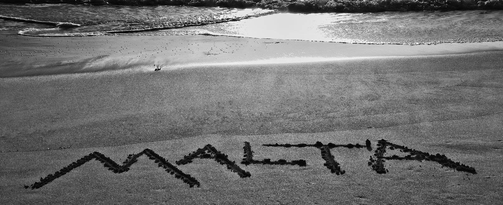 The word Malta spelled out in the sand at Golden Bay in Malta