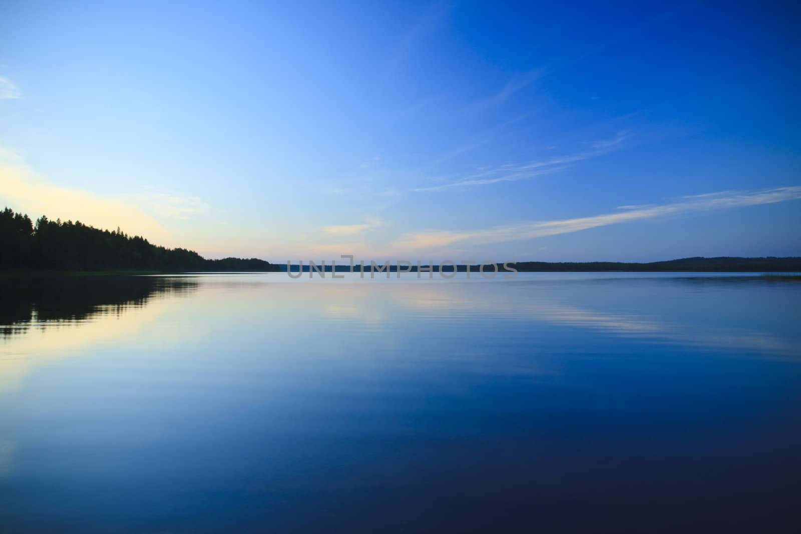 sunset on lake with sky reflections  on the water