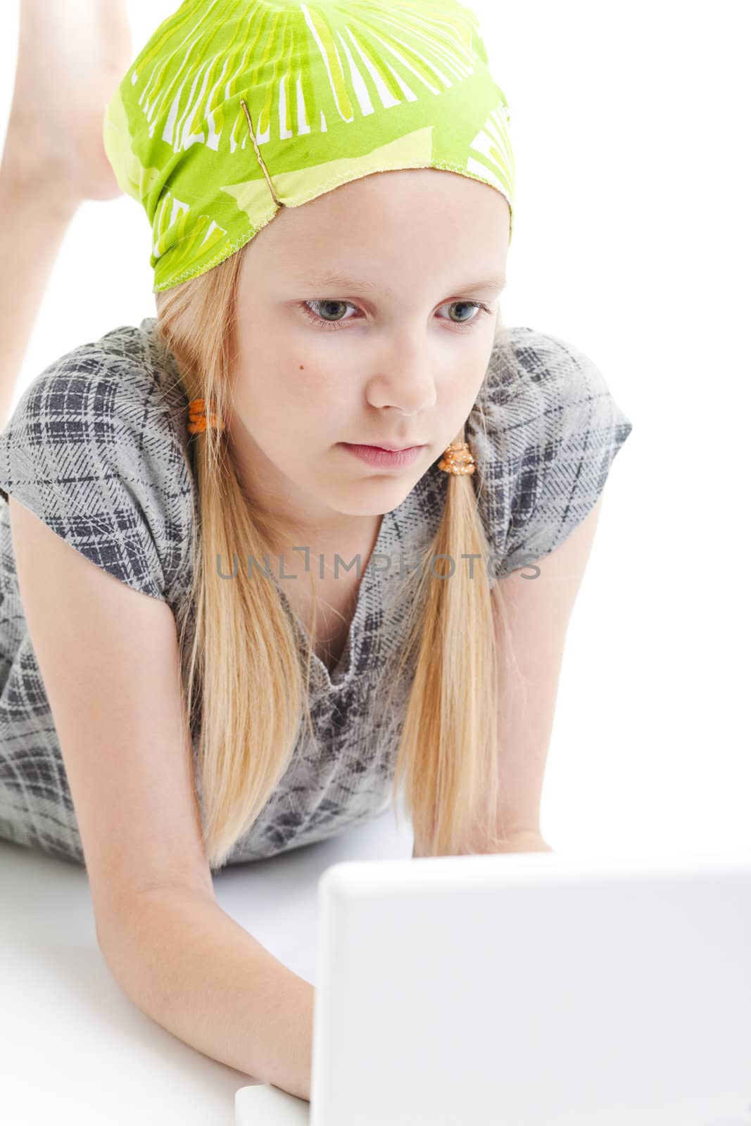 Young girl using a laptop computer over white background