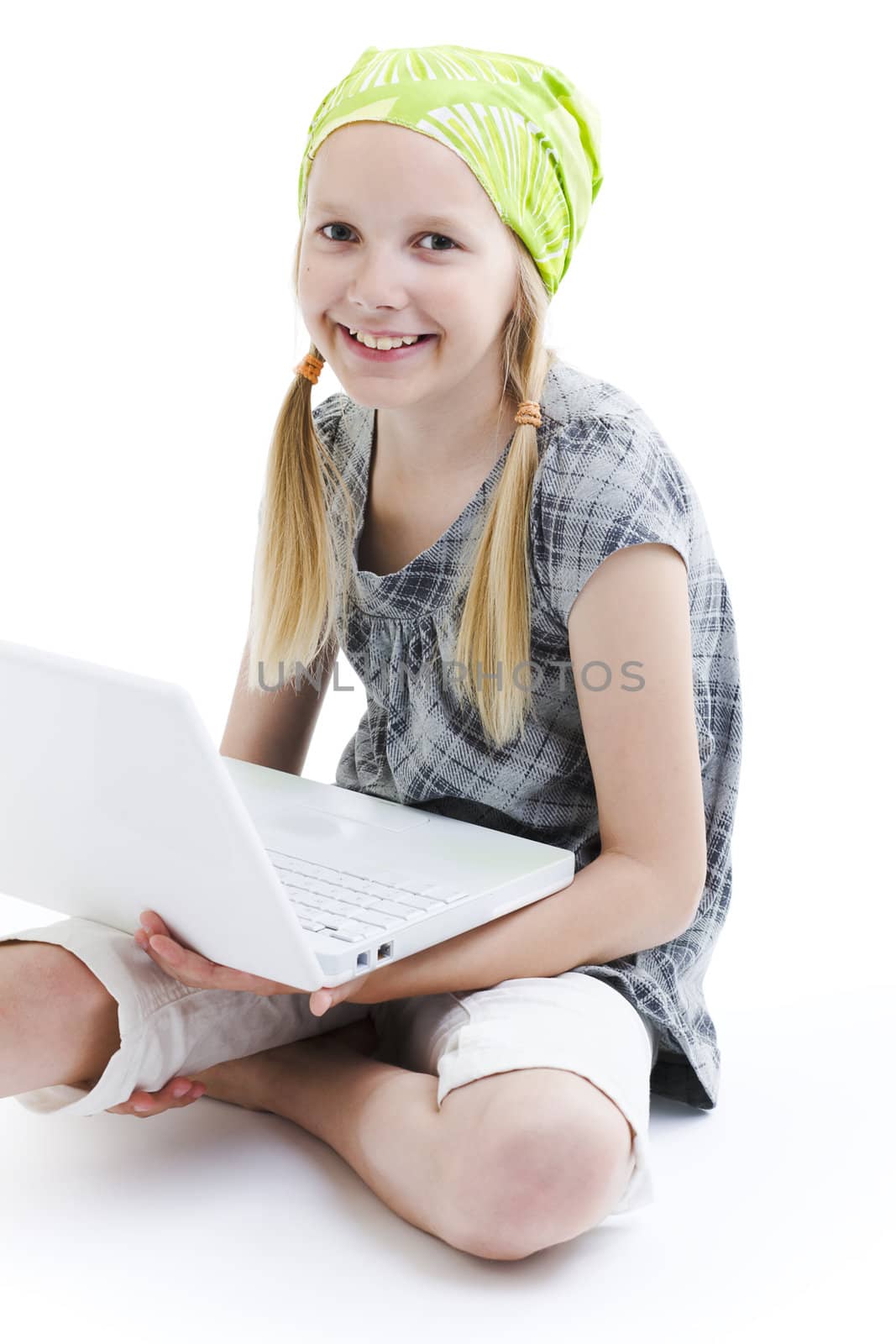 Young girl using a laptop computer over white background