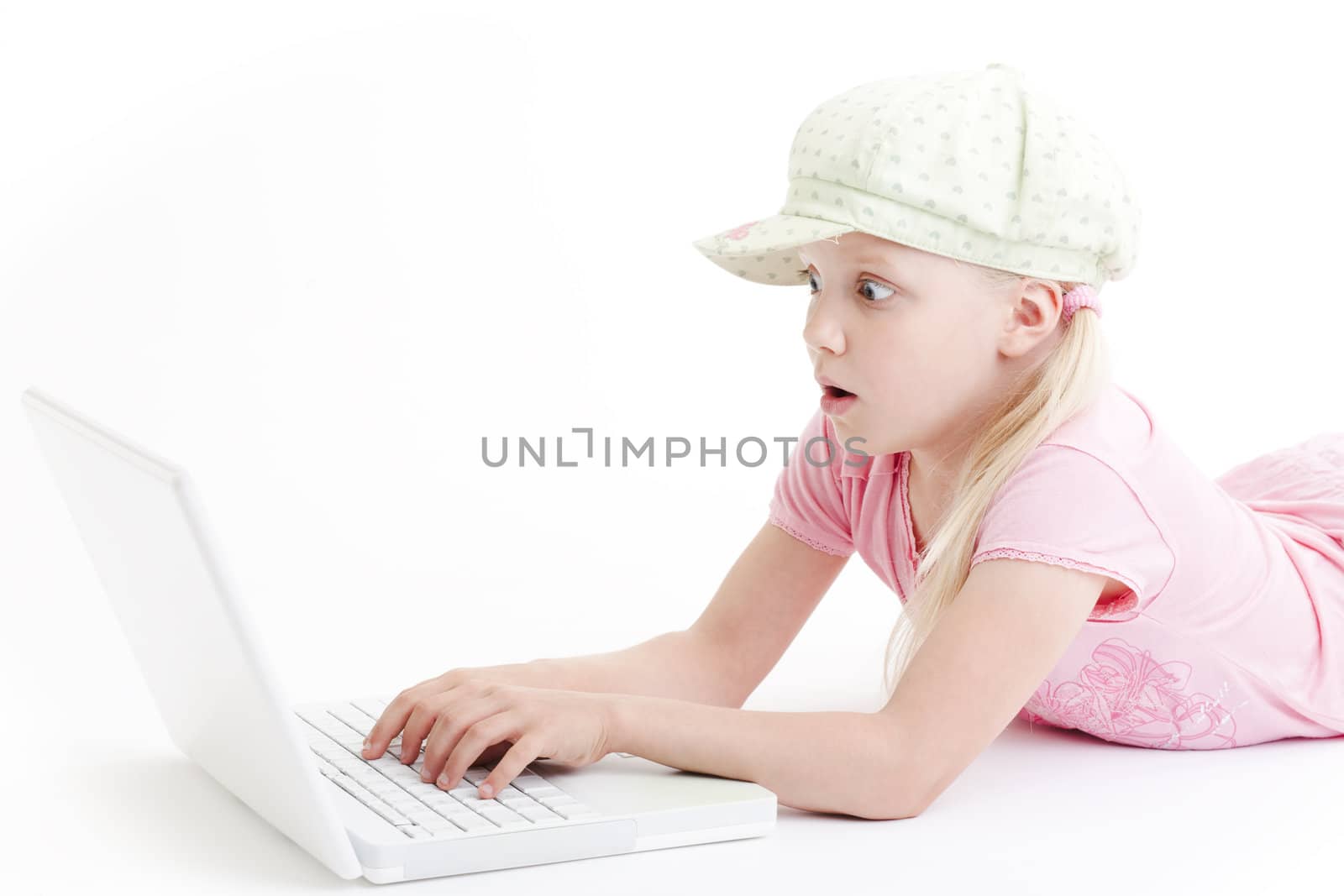 Young girl using a laptop computer over white background