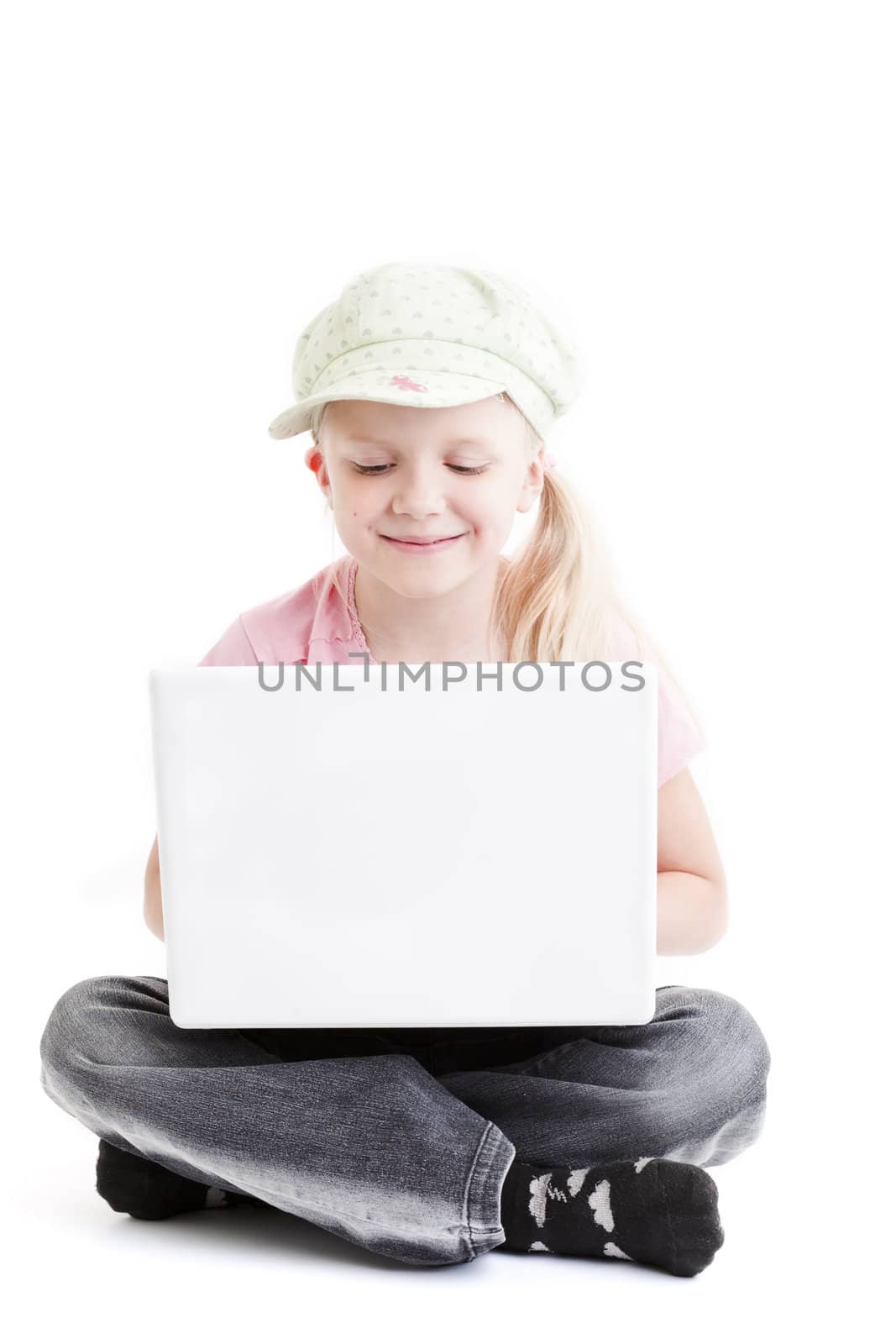 Young girl using a laptop computer over white