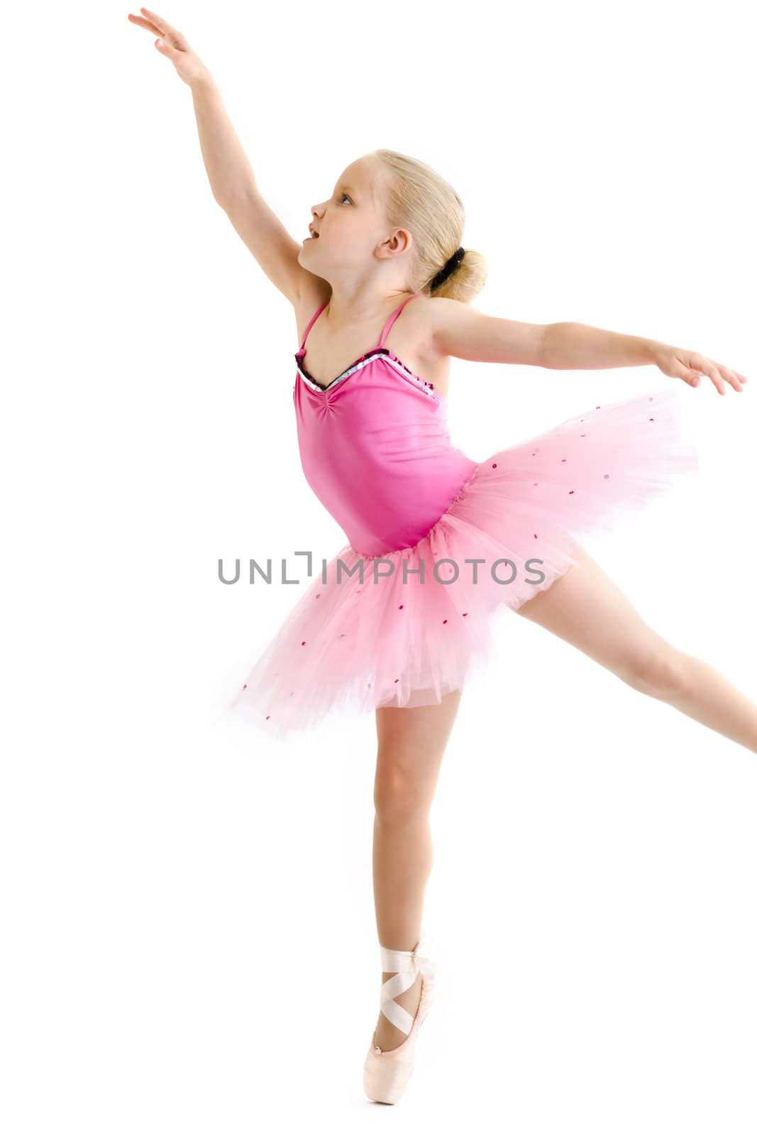 Young ballerina standing on pointe in toe shoes