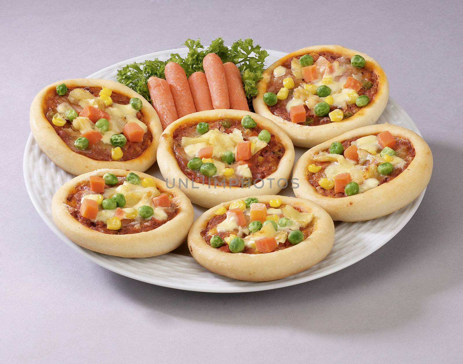 Small pizzas on a round plate.