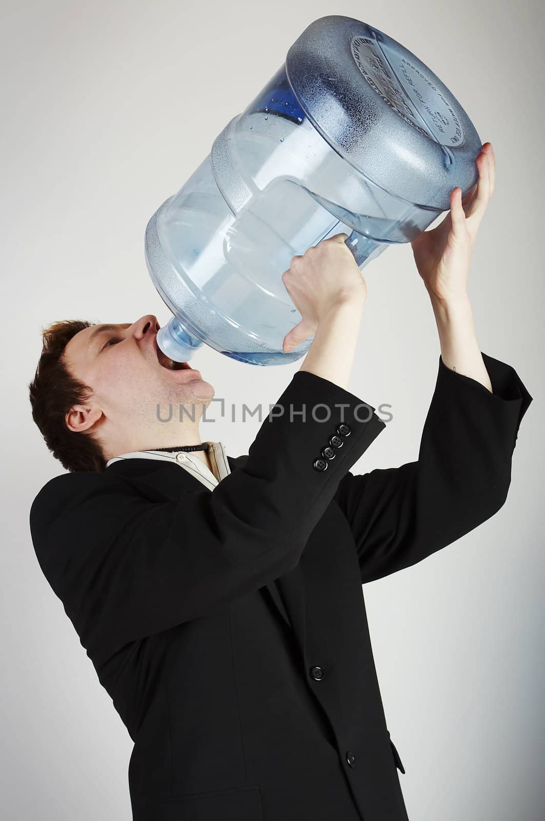Man drinking water from huge water bottle