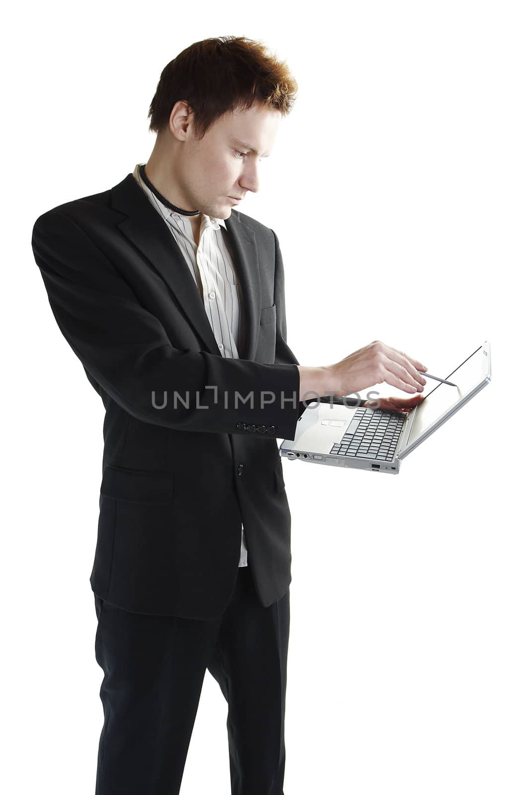 Isolated young businessman using a touchscreen laptop