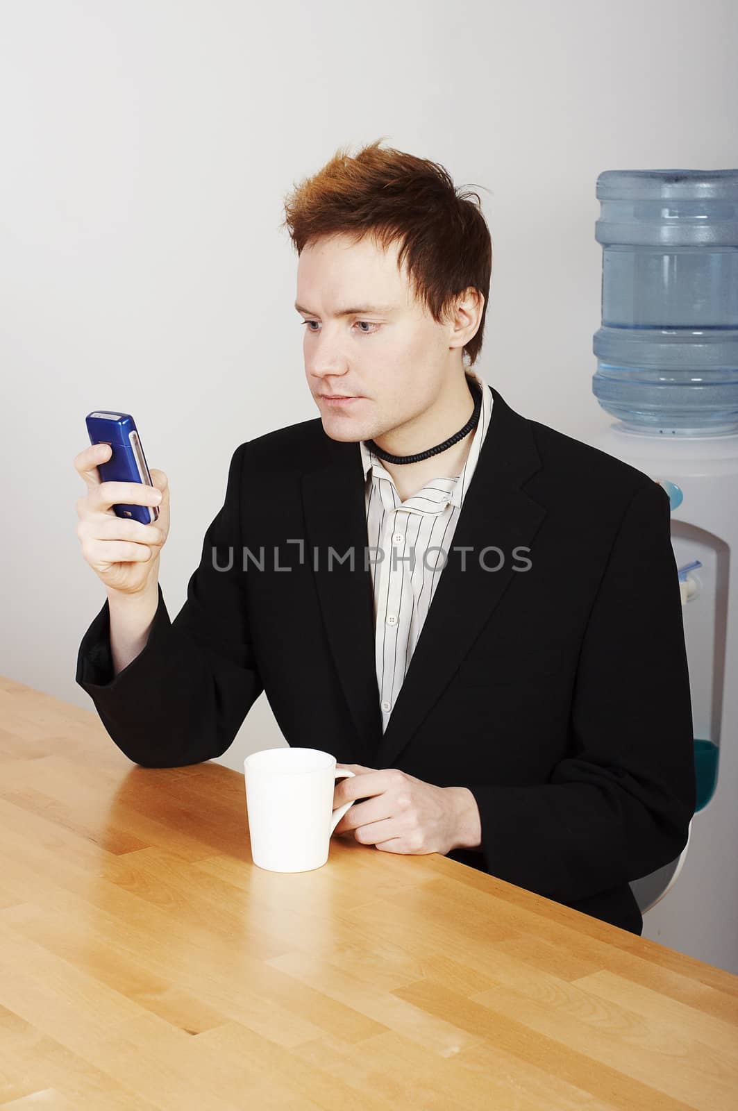 Businessman with coffee cup and mobile phone