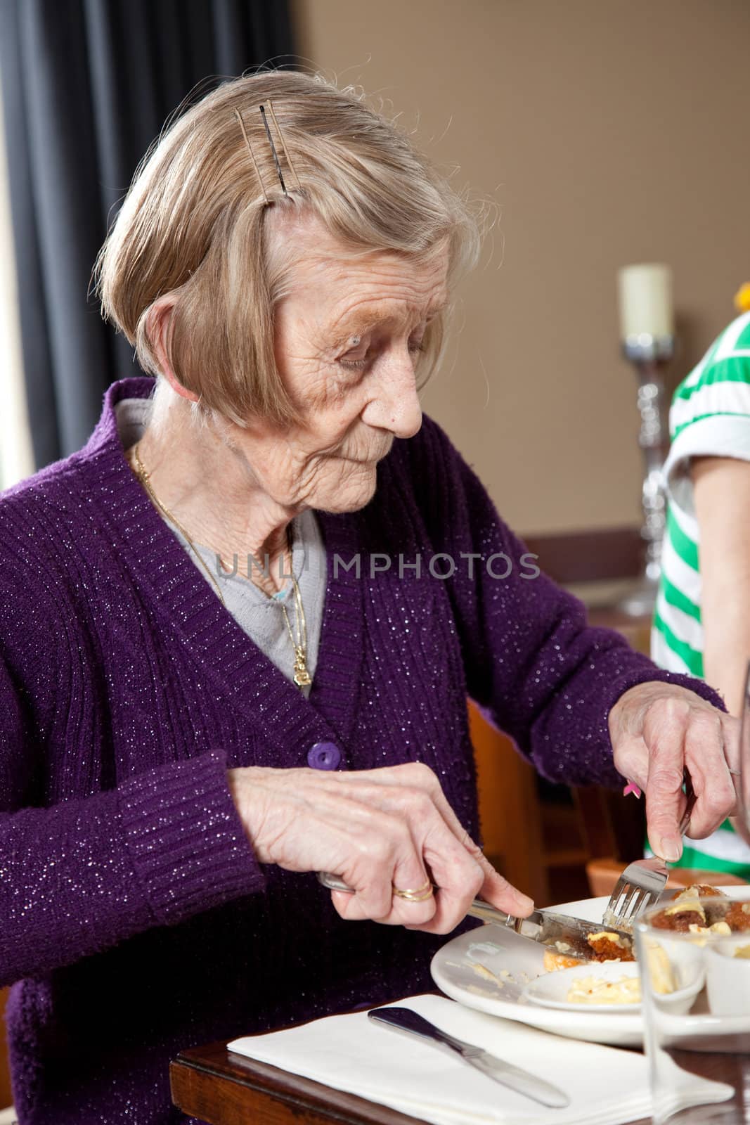 Lady of 80 years old having lunch in a restaurant