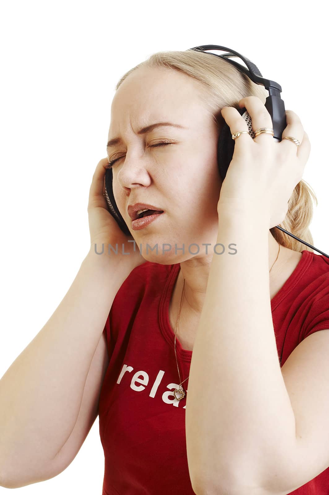 Isolated young woman listening music on earphones and sining along
