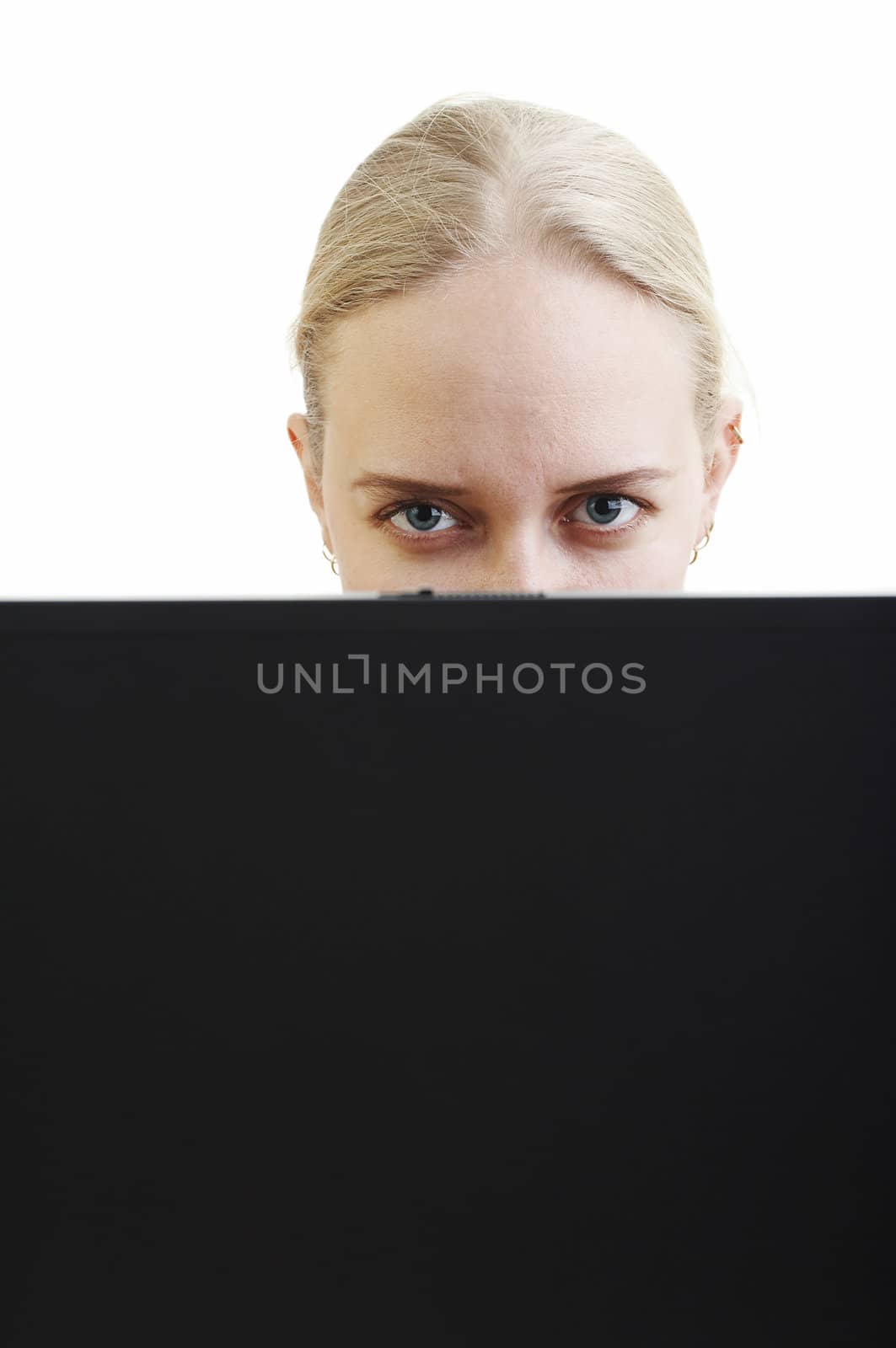 Working blonde woman behind laptop lcd screen 