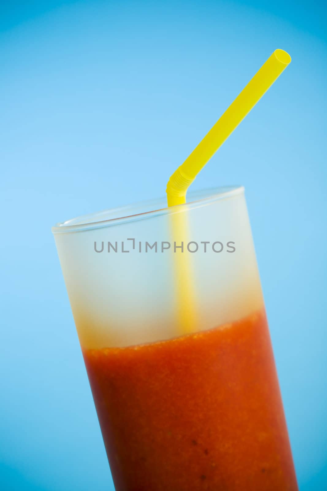 Strawberry smoothie over a light blue background