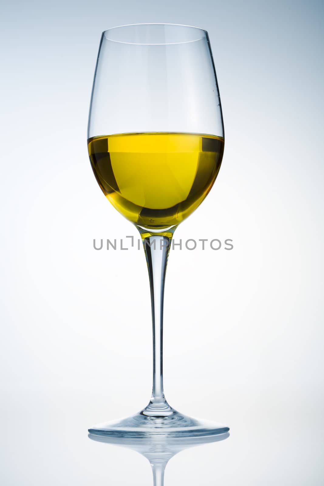 Glass of white wine over a light background