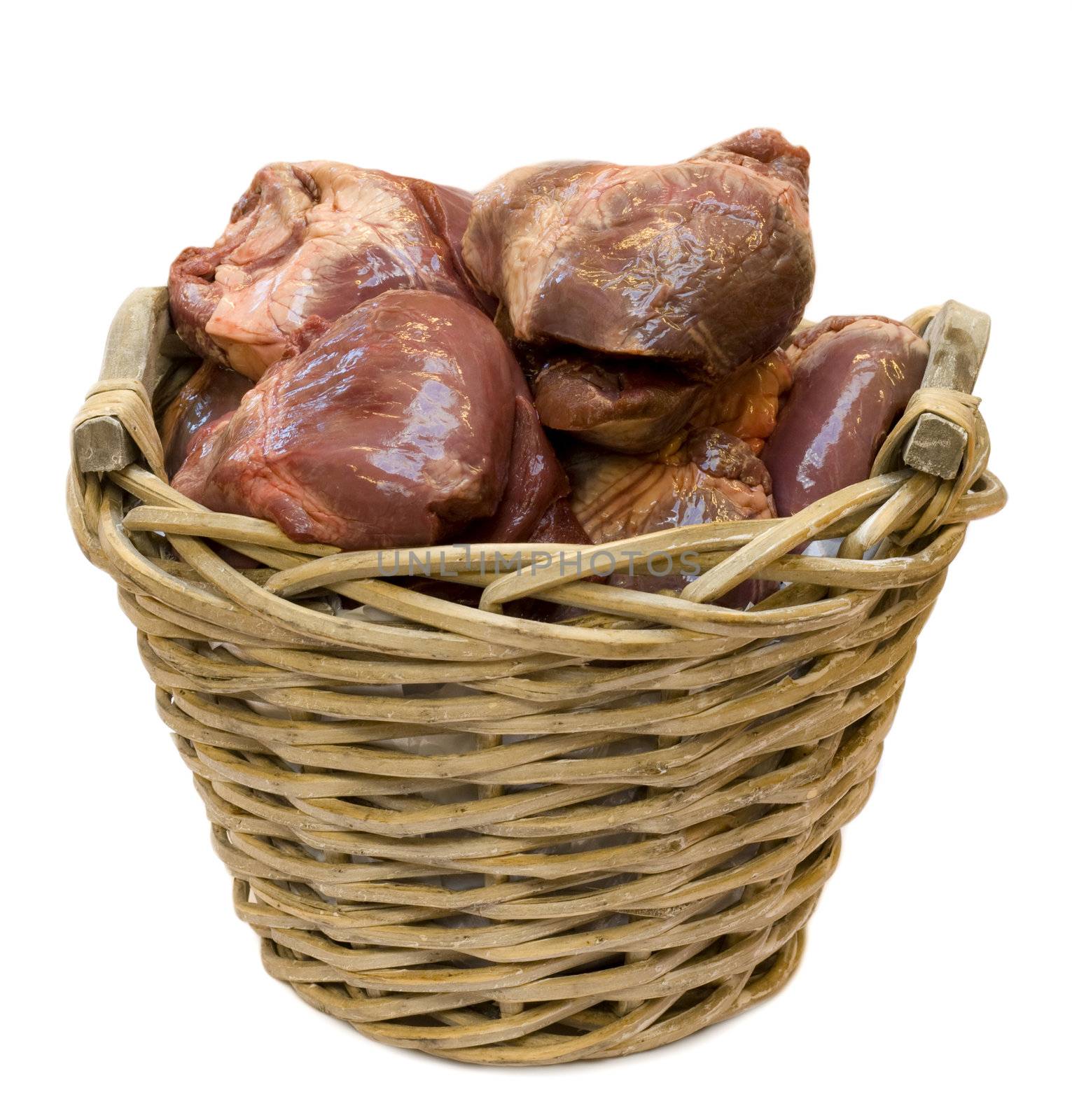 Basket filled with raw swine hearts, isolated on white background.