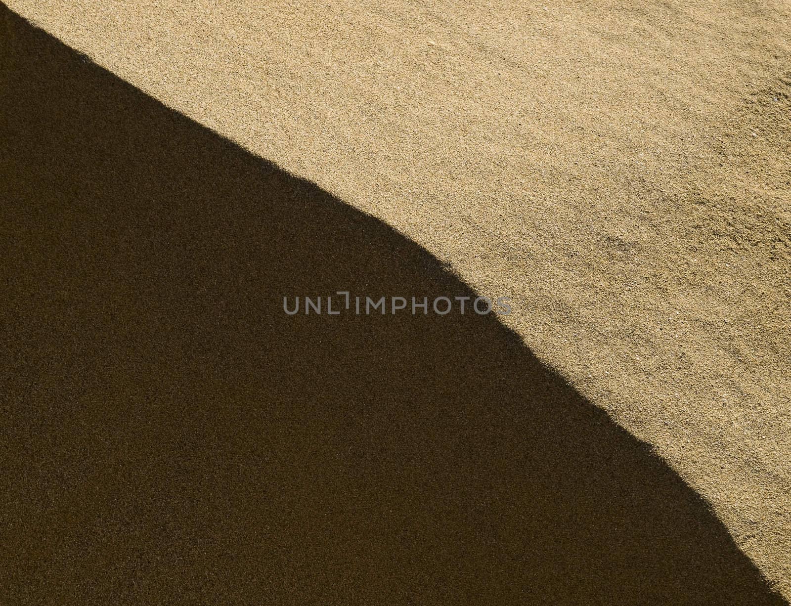 Abstract image showing detail of sand dunes in light and shadow at Golden Bay in Malta