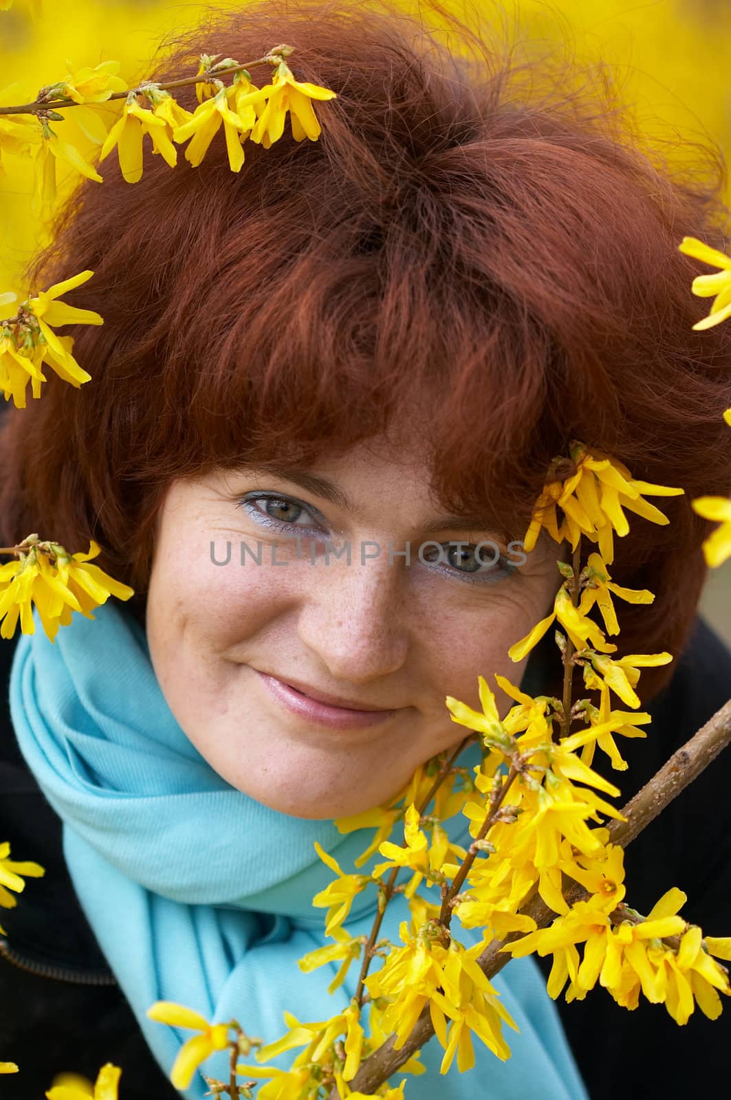 Portrain of girl in blooming yellow bush