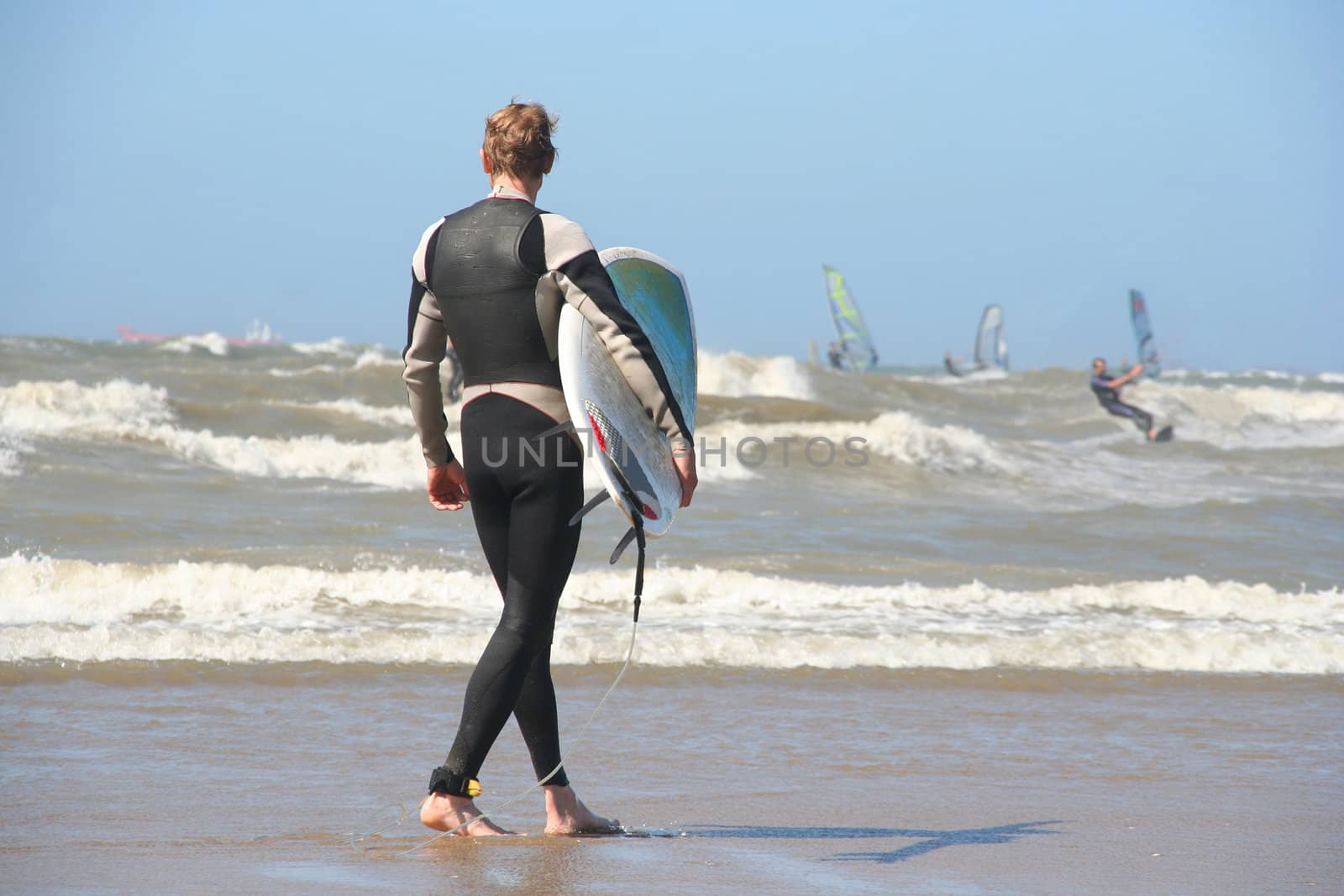 Scheveningen Surf Competition: Surfer with his surfboard walking into the surf