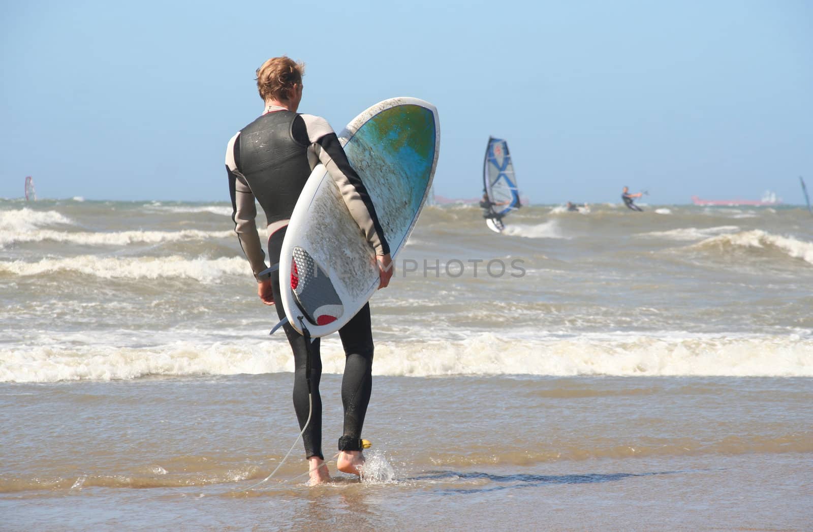 Scheveningen Surf Competition: Surfer with surfboard walking into the surf