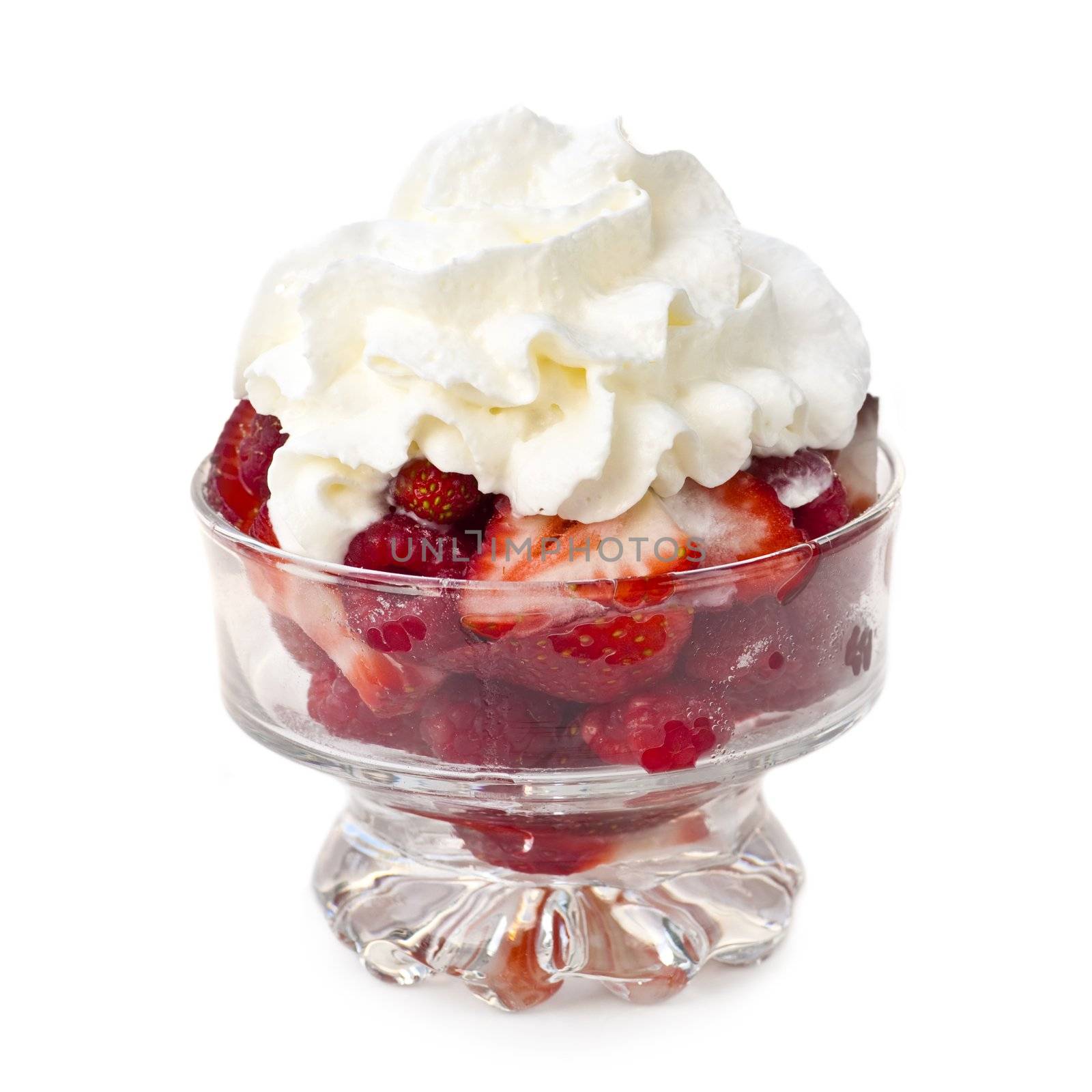Fresh raspberries and strawberries with whipped cream in glass bowl isolated on white