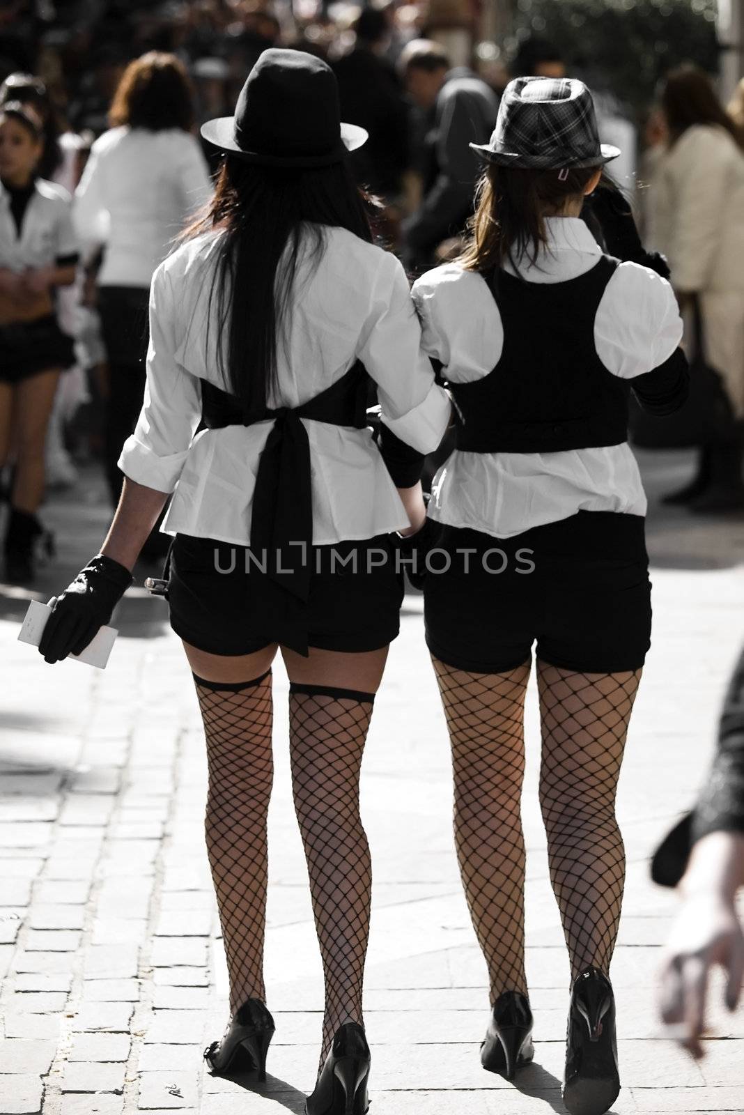 Two women walking in the street wearing sexy and provocative clothing