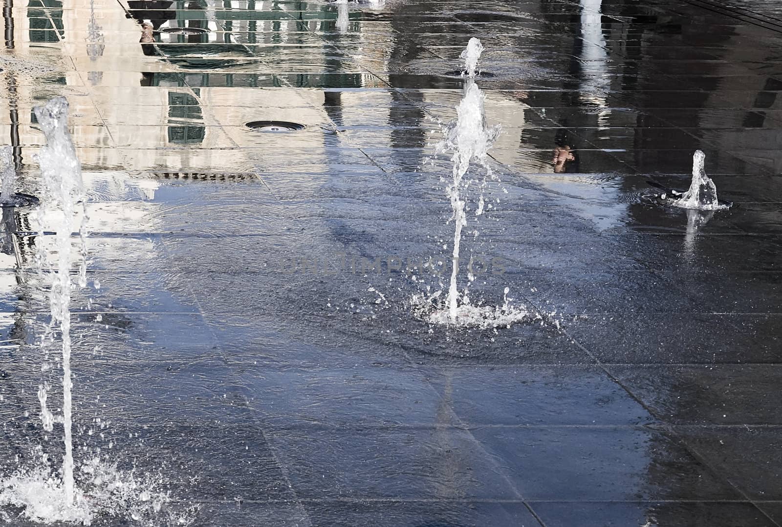 Jets of water and reflections at Palace Square in Valletta in Malta