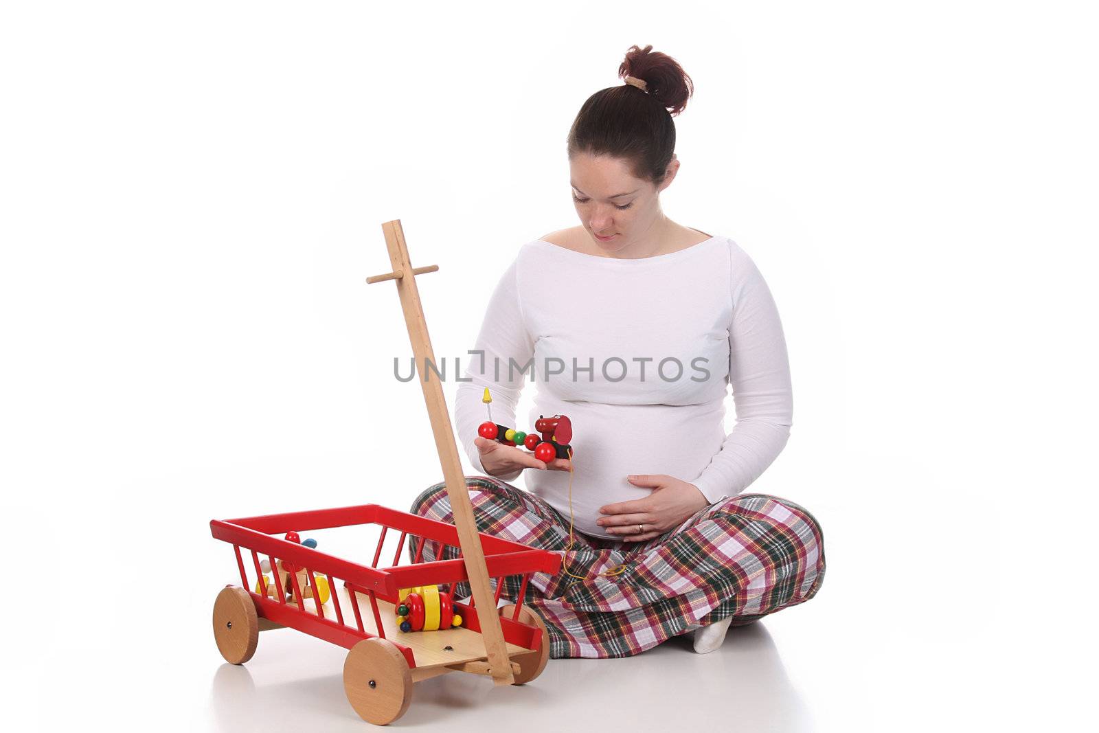 pregnant woman and toys on white background