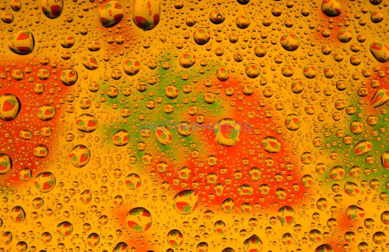 Water drops over strawberries background (close-up photo)
