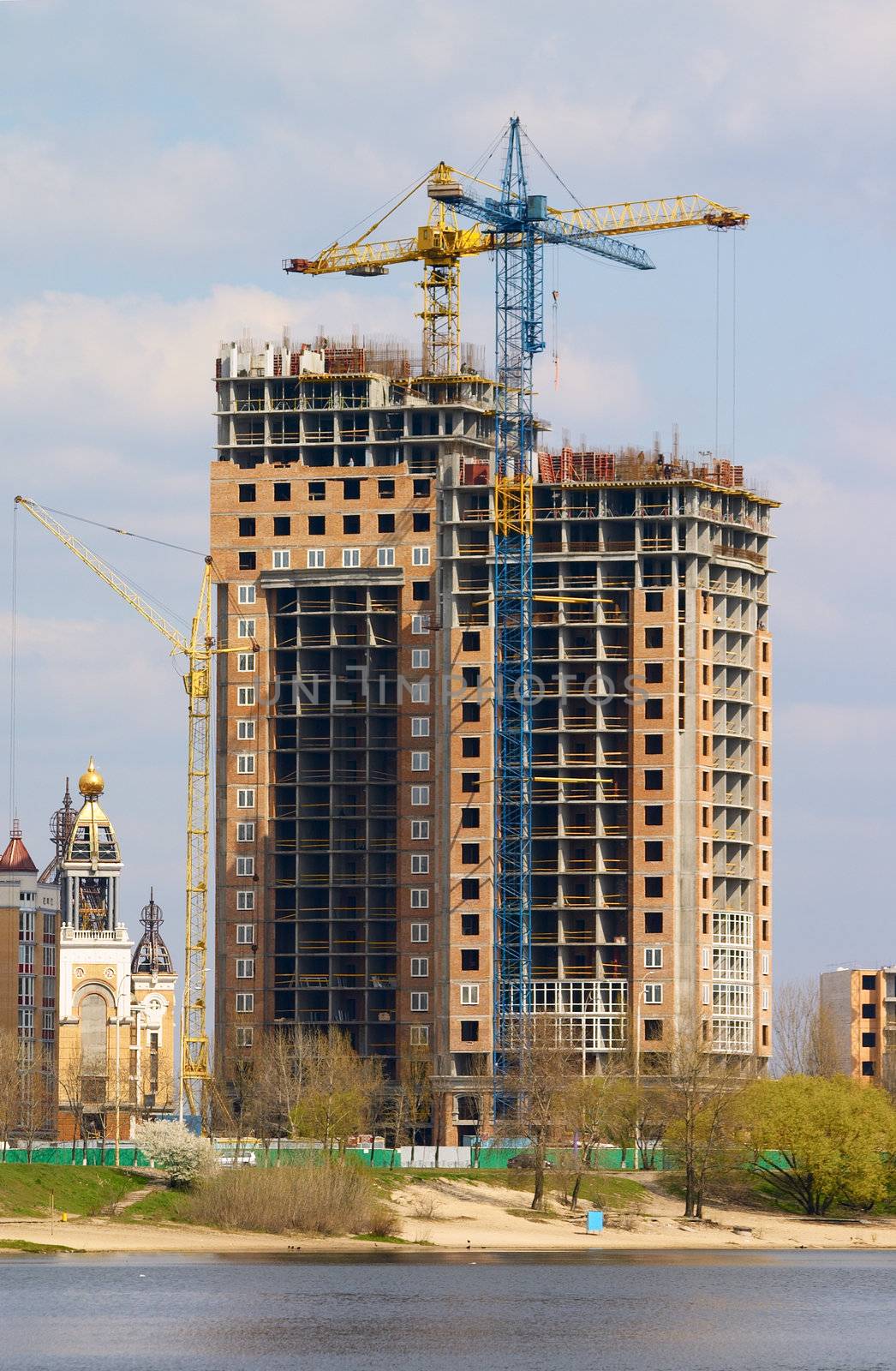 Cranes building the house on the coast