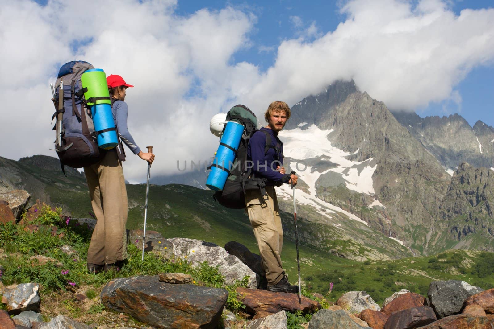 Couple of mountain-climber tourist travelling in high mountains