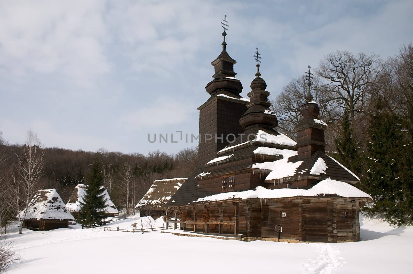 Old wooden church in the snowy countryside lndscape