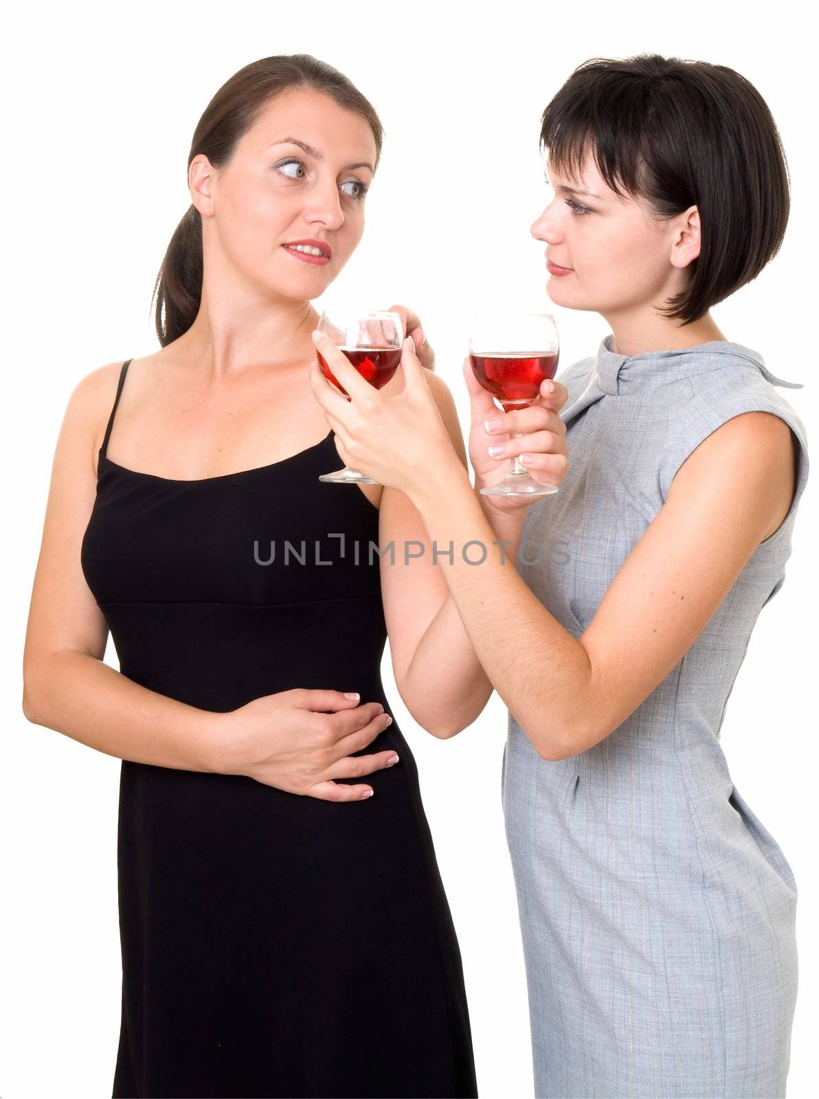 Party. Two beautiful girls with wine, isolated on white.