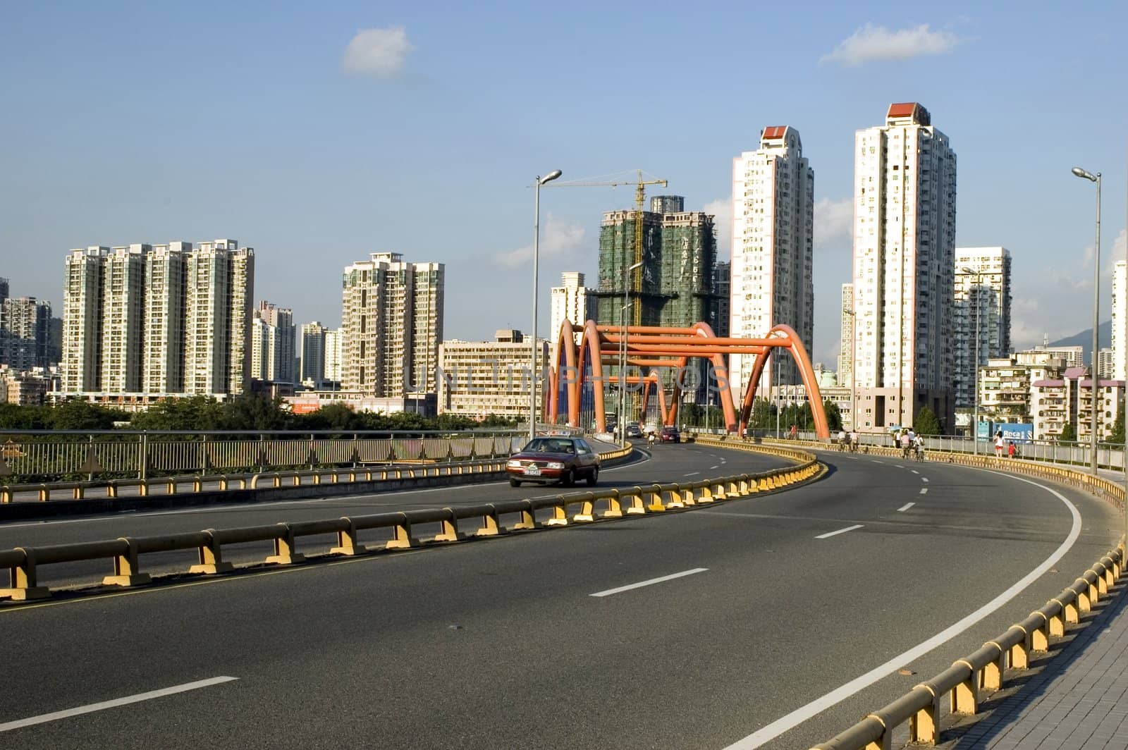 Chinese city - Shenzhen, residential area in Luohu district, high buildings, road and orange bridge. 