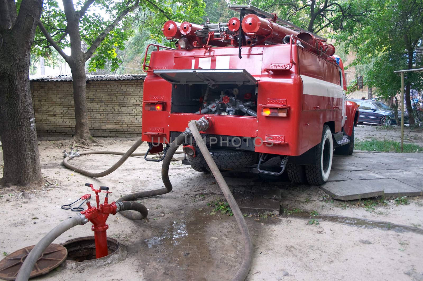 fireengine connected to firecock by firehose