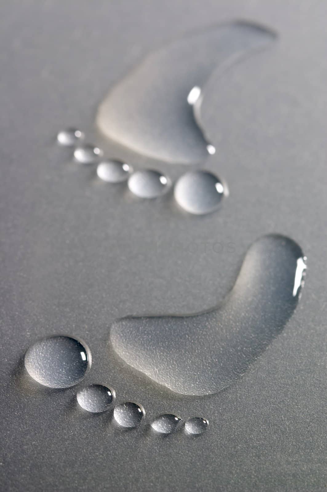 Bare human footprints made from drops of water