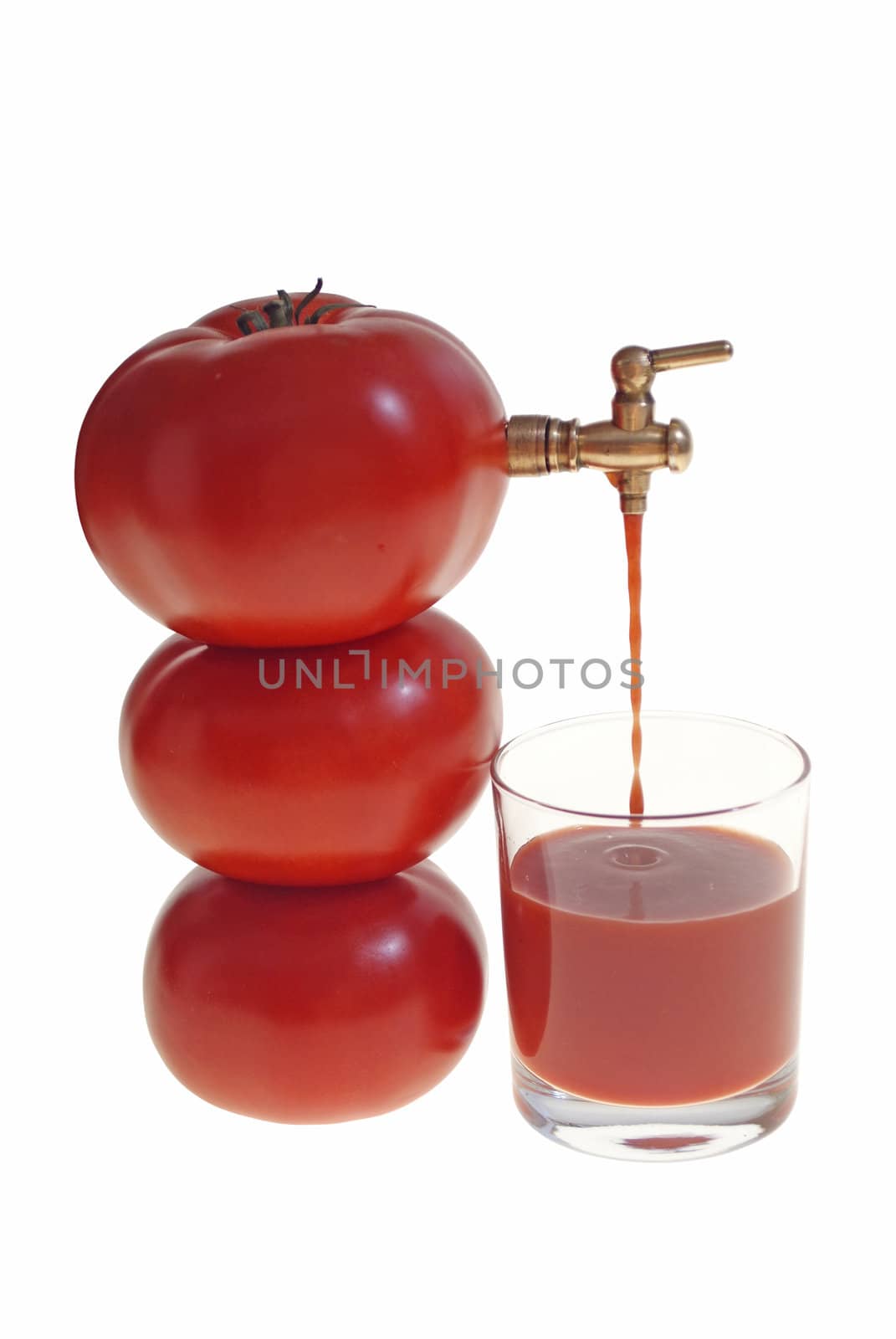juice flowing from tomato to glass isolated on white background