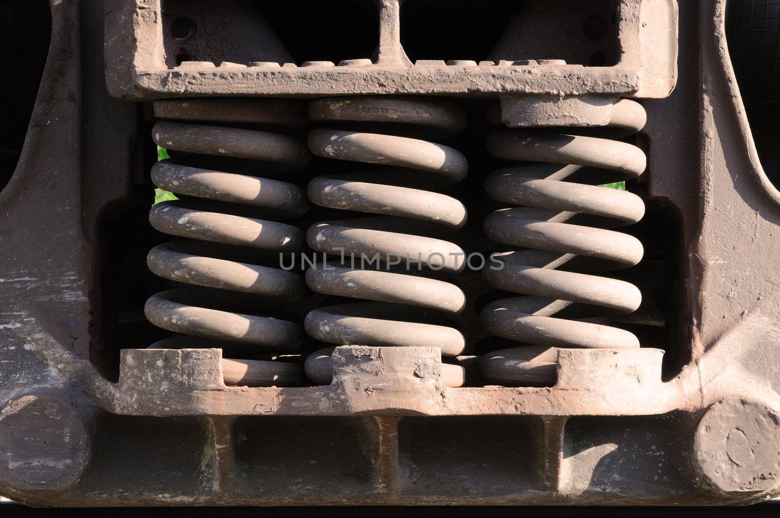 a trio of heavy-duty springs on the side of a train car