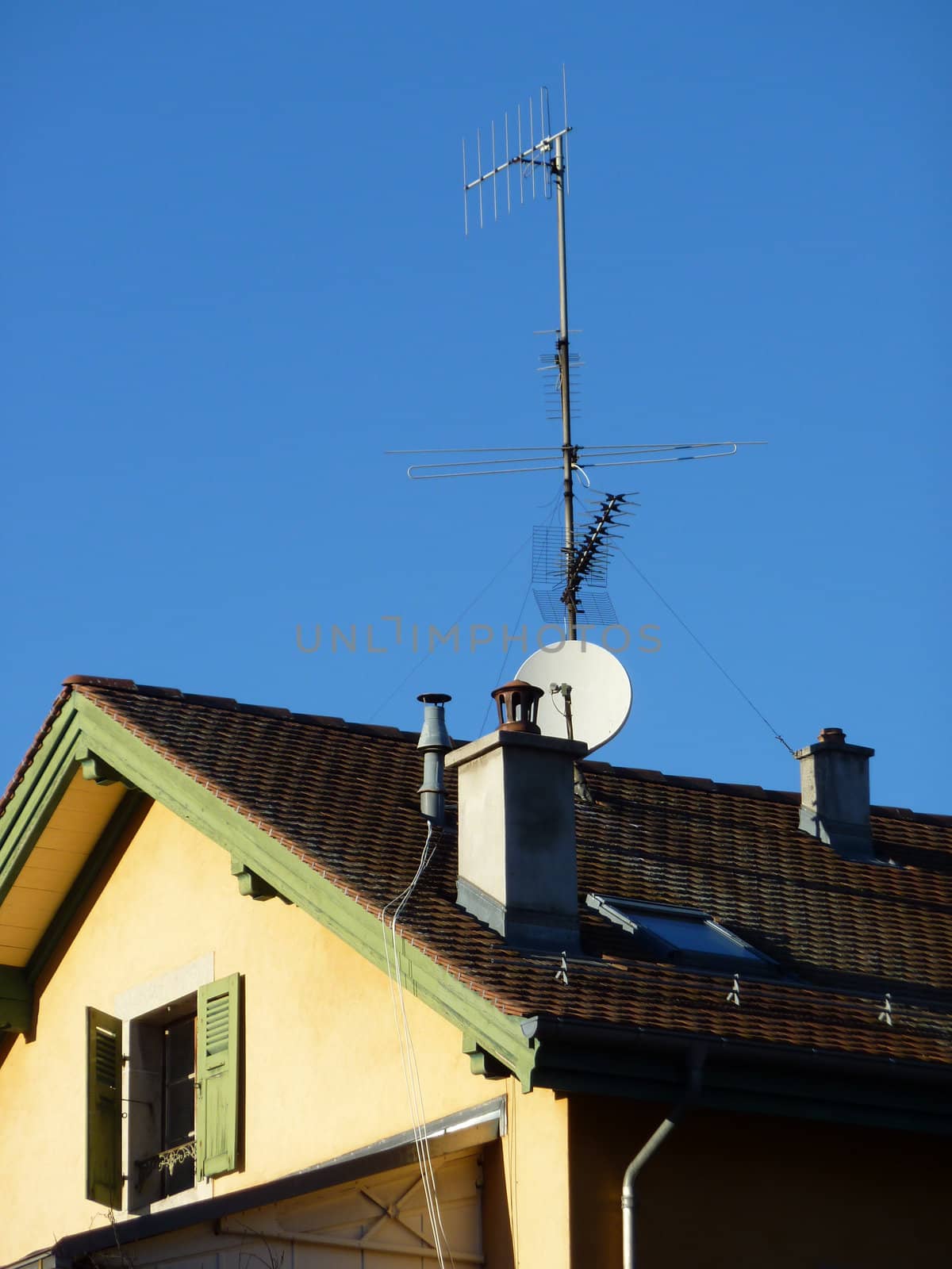 Antenna on a sunny roof by beautiful weather