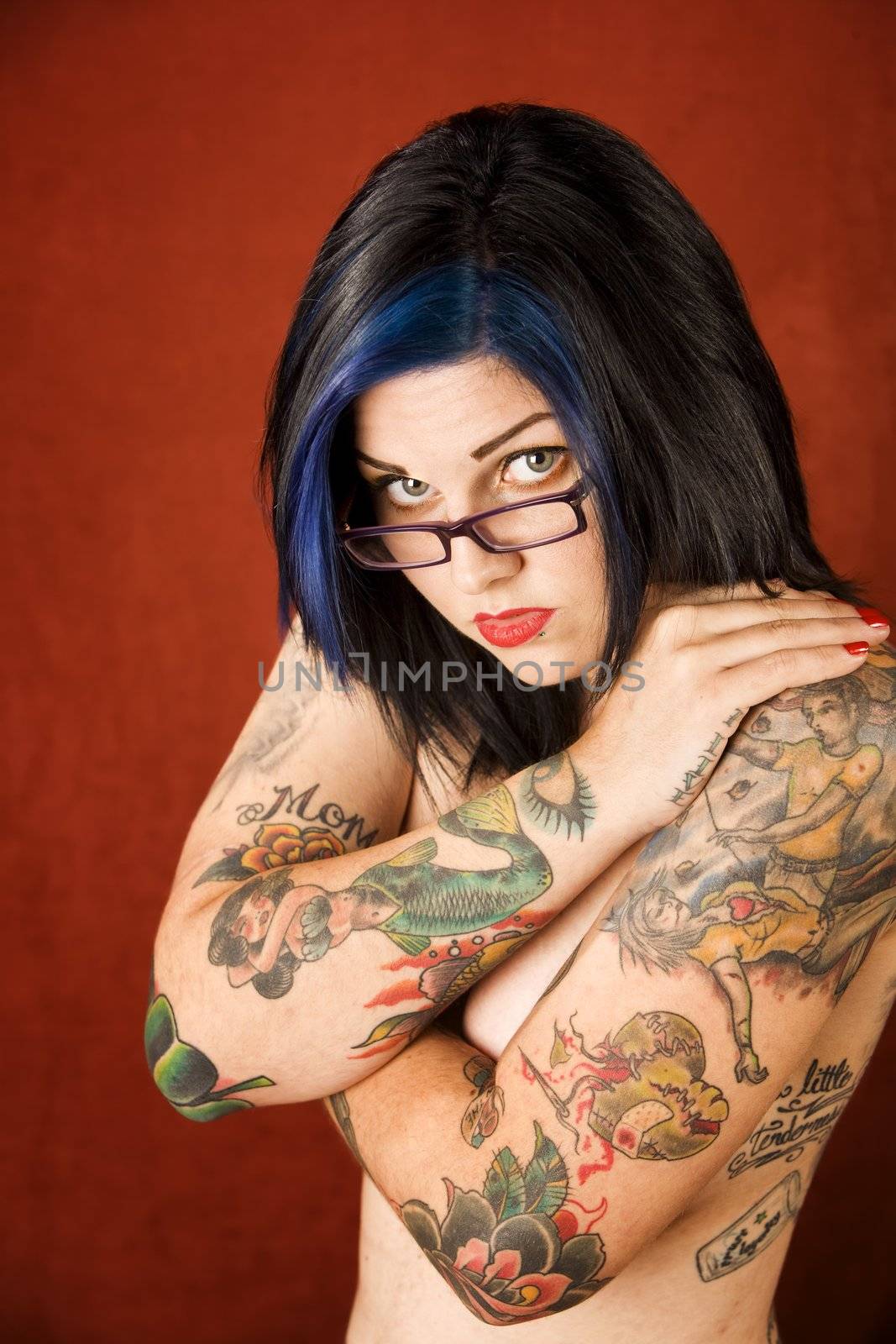 Woman with tattoos and crossed arms by Creatista