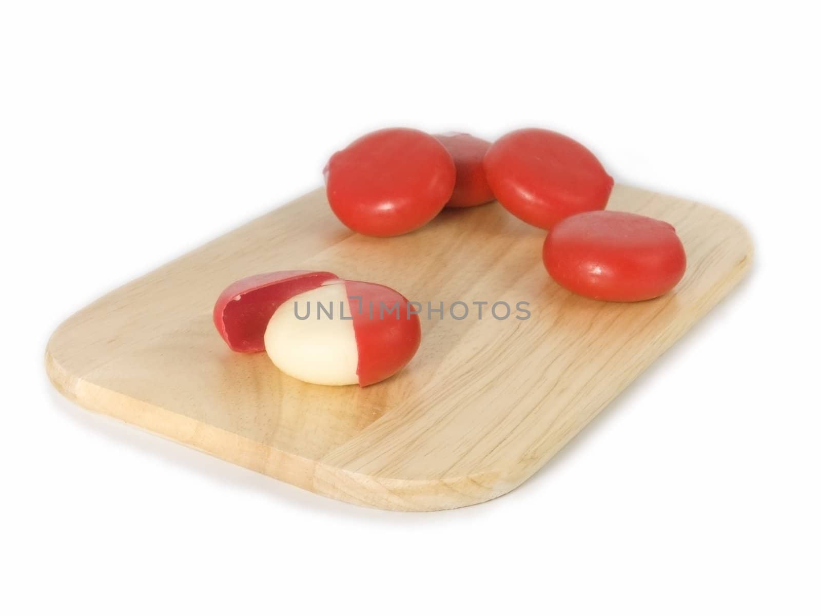 cheese and tomatoes on board isolated on white background