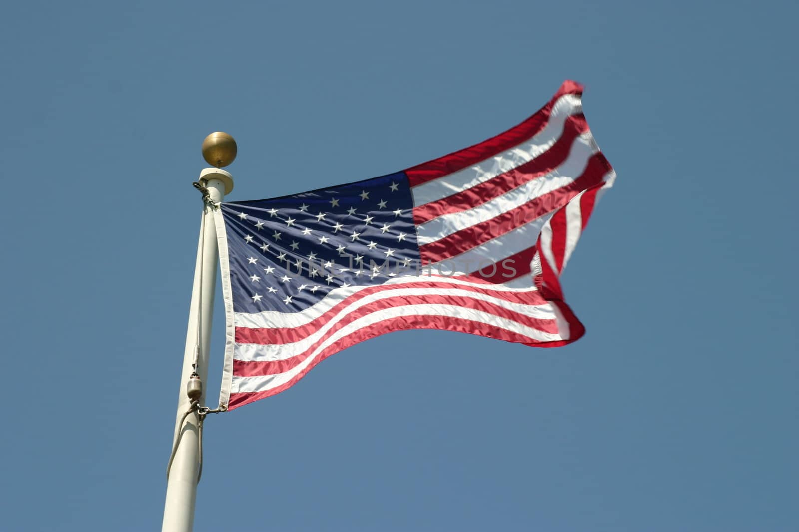 The flag of the United States Of America with the sky in the background