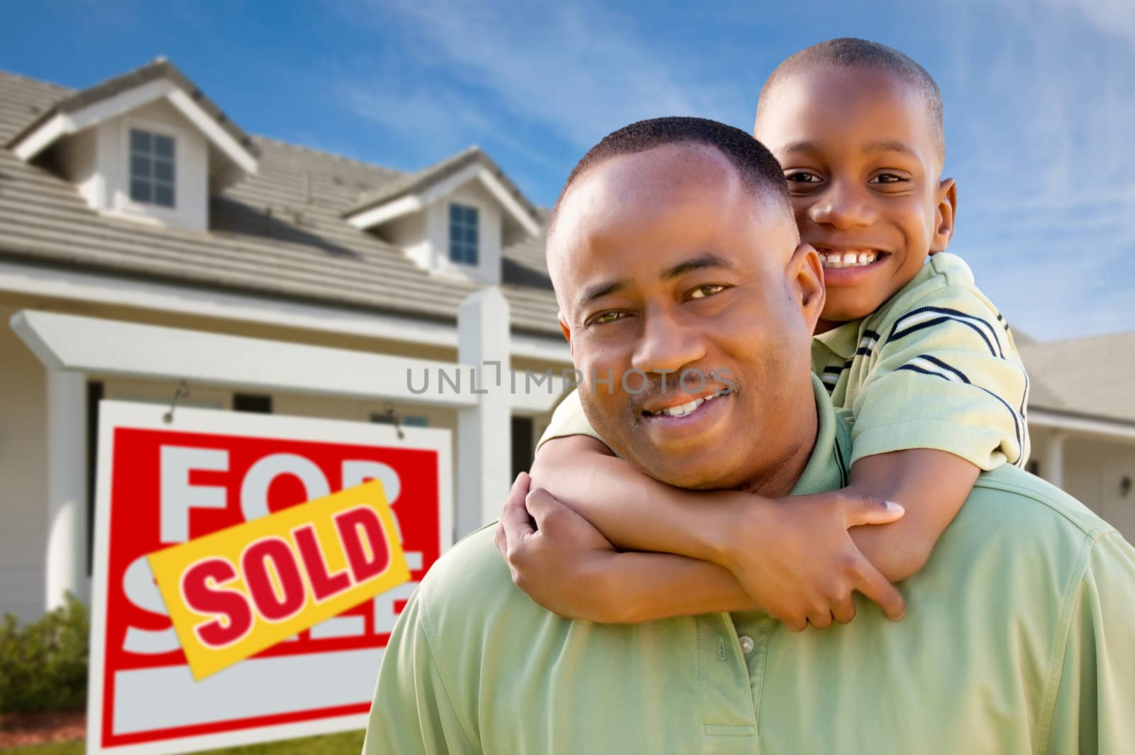 Father with Son In Front of Real Estate Sign and Home by Feverpitched