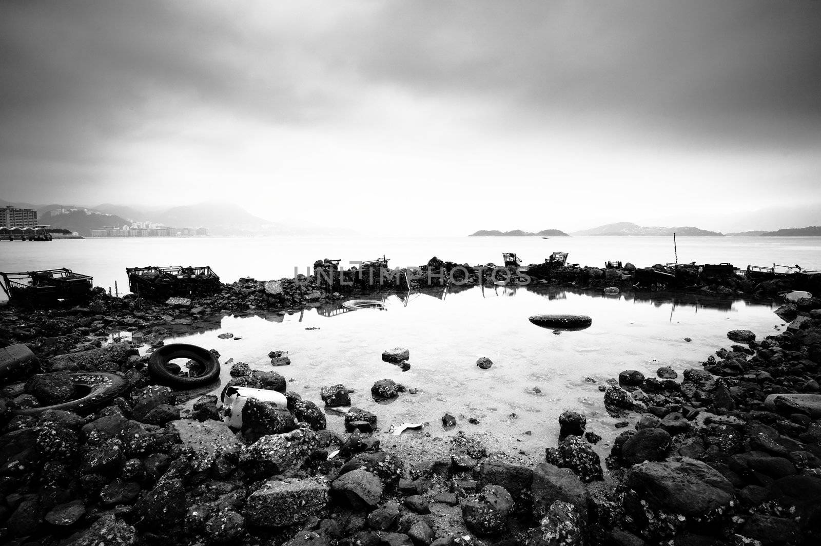 some wasted stuffs at the coastline, black and white