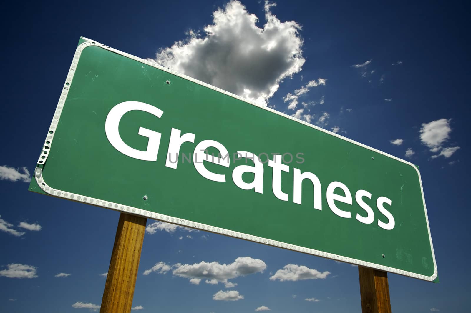 Greatness Road Sign with dramatic clouds and sky.